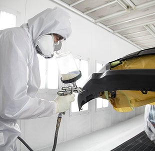 Collision Center Technician Painting a Vehicle | Toyota of Katy in Katy TX