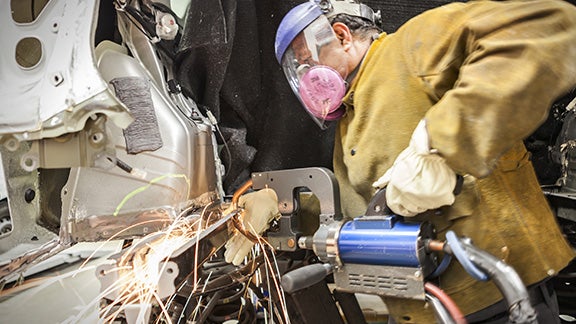 Collision Center Technician Repairing Vehicle | Toyota of Katy in Katy TX