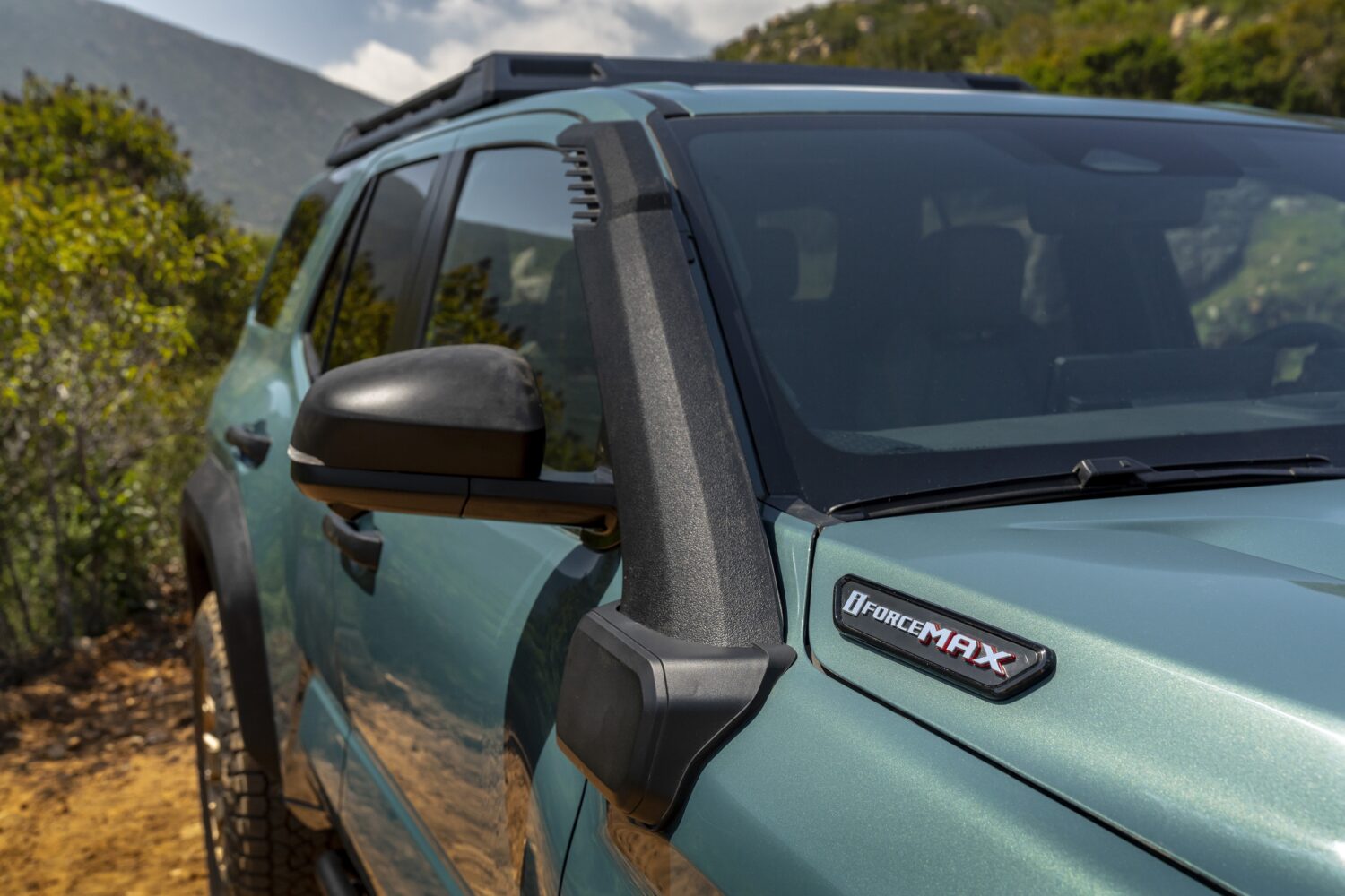 A close up shot of the i-FORCE MAX logo on a Hybrid 4Runner