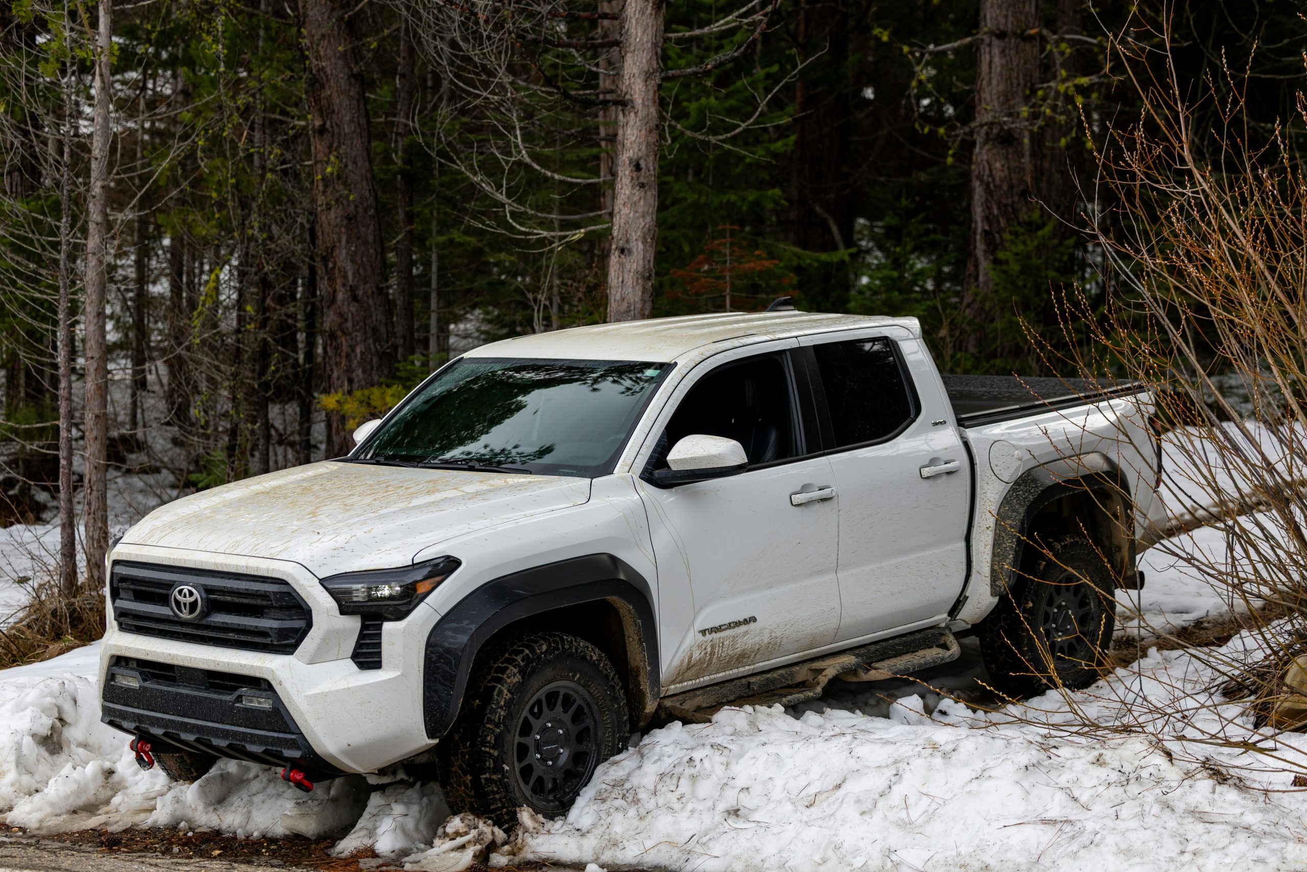 A white Toyota Tundra driving through snow