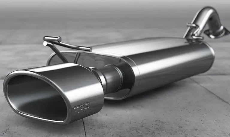 A polished, silver car exhaust muffler with a rounded, oval tip featuring 