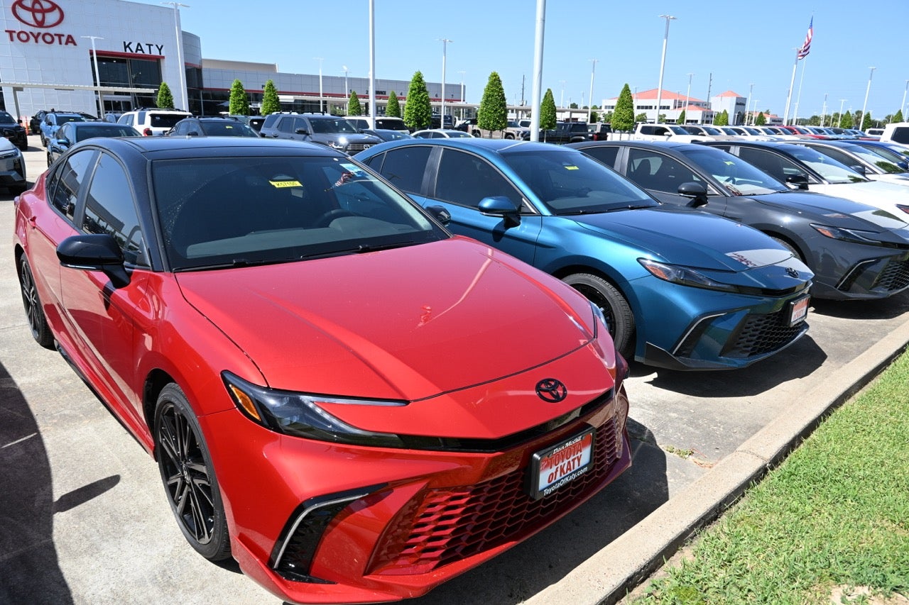Two 2026 blue and white Toyota Camrys at Toyota of Katy