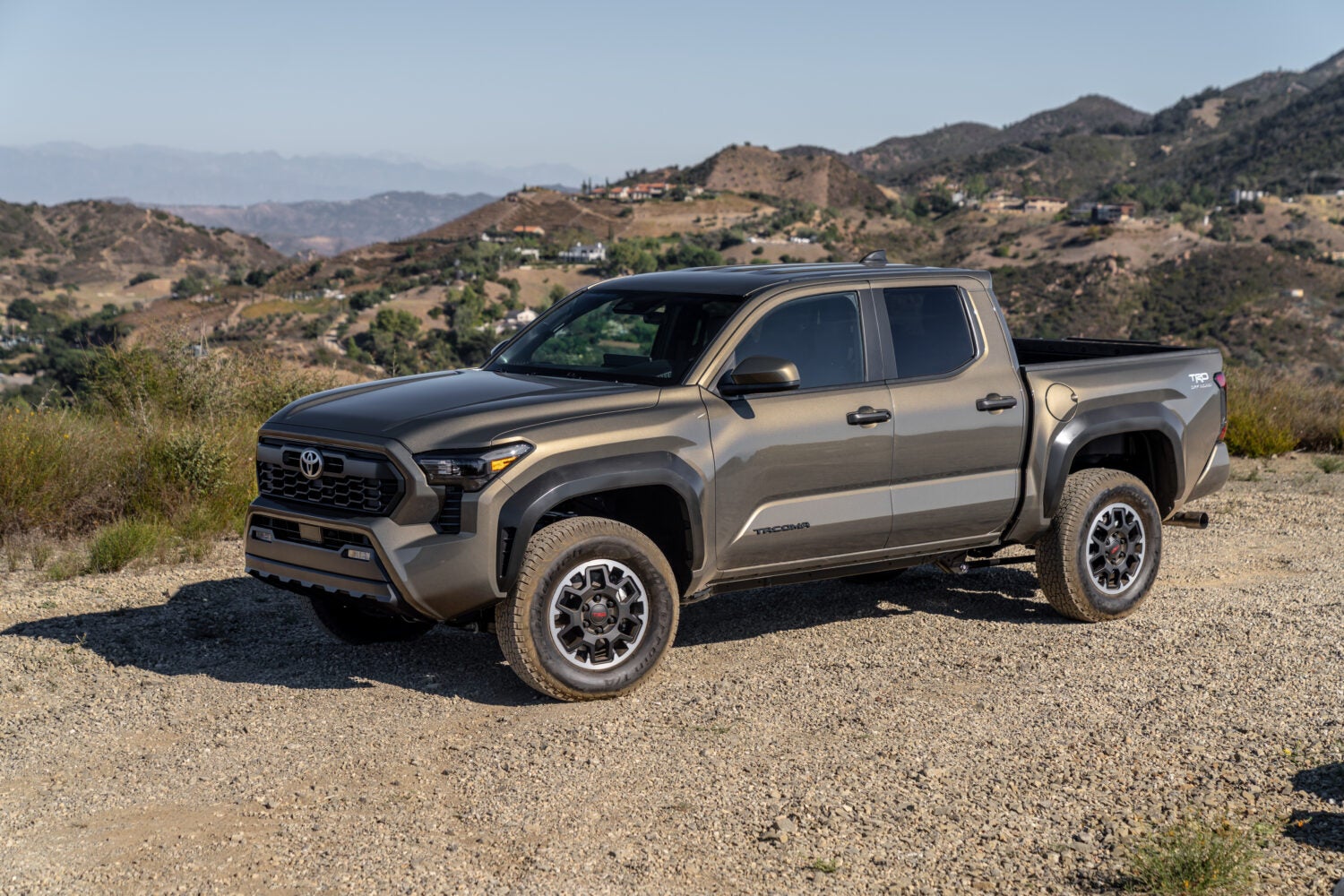 A bronze oxide 2026 Toyota Tacoma TRD Off Road on a gravel road
