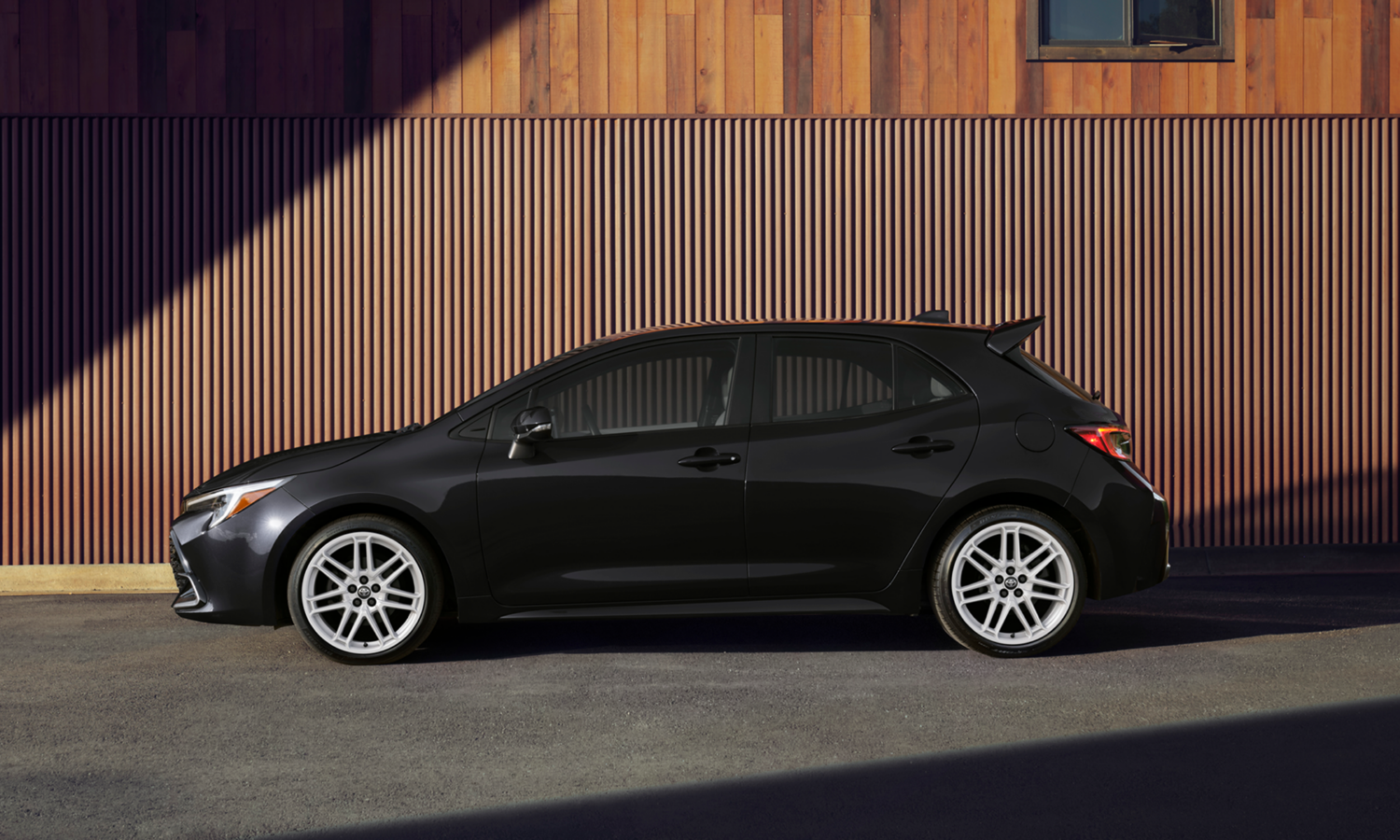A side profile of a black 2027 Corolla Hatchback